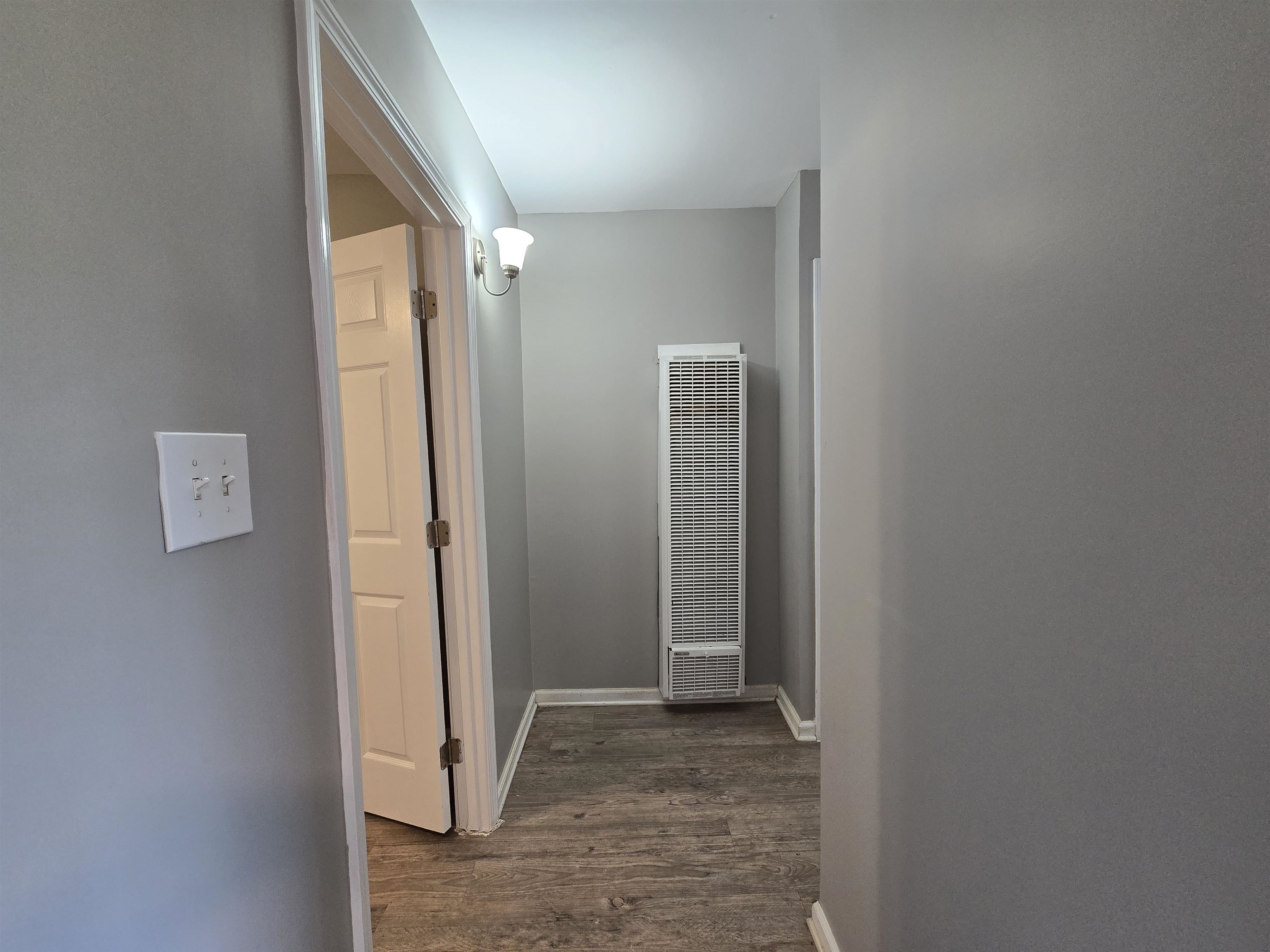1572 Hanauer Street Memphis, TN 38109 - Photo 9 of 39 Hall with a heating unit, dark wood finished floors, and baseboards