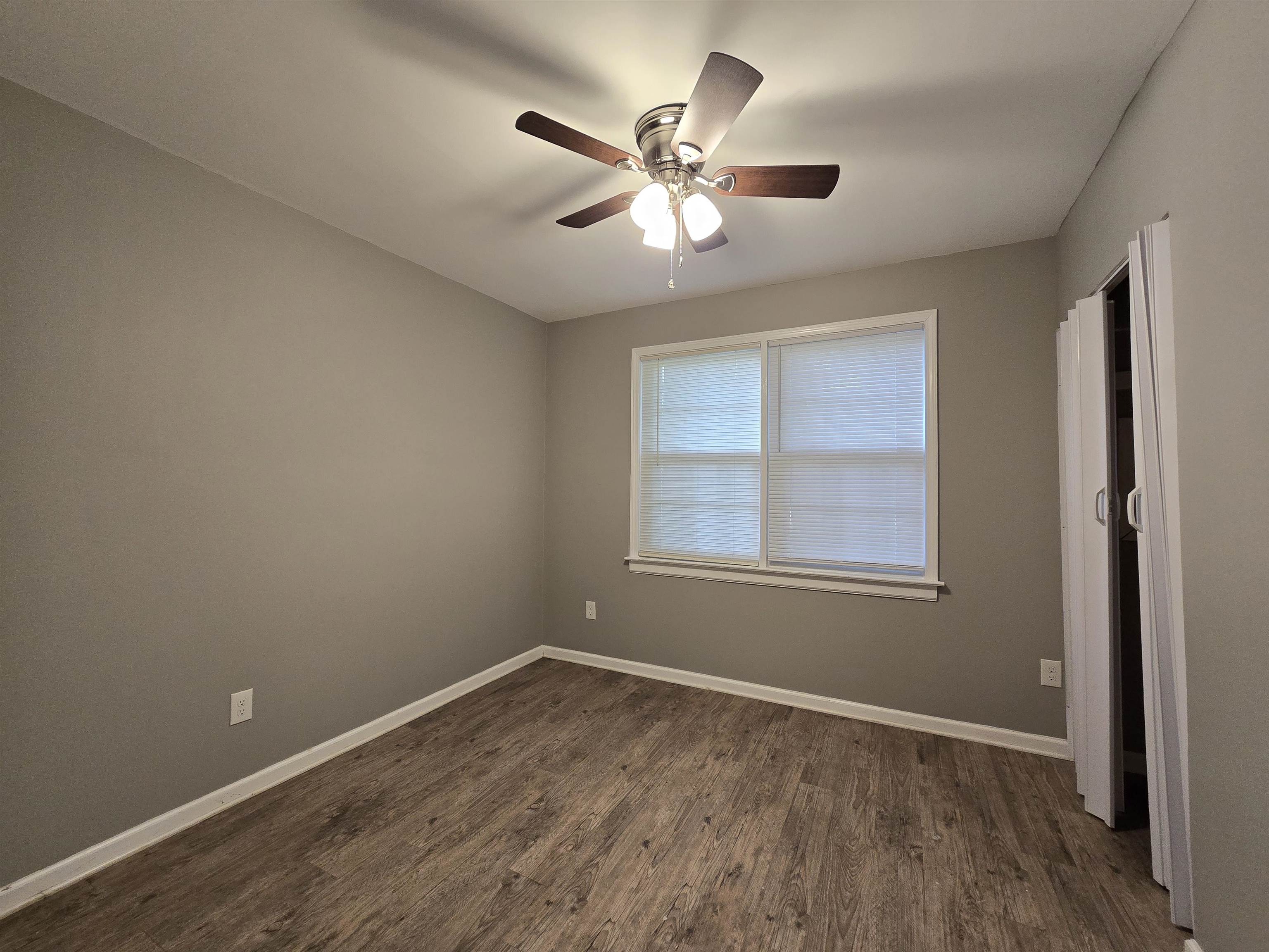 1572 Hanauer Street Memphis, TN 38109 - Photo 10 of 39 an empty room with wooden floor fan and windows