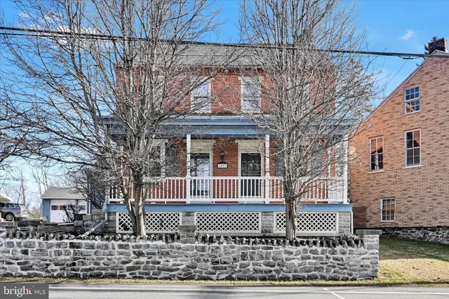 front view of a house with a bench