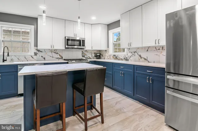 a view of a living room a dining room with furniture and wooden floor