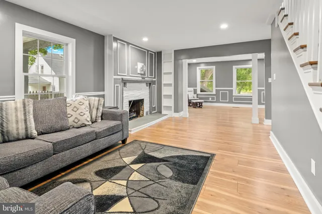 a living room with furniture and a fireplace