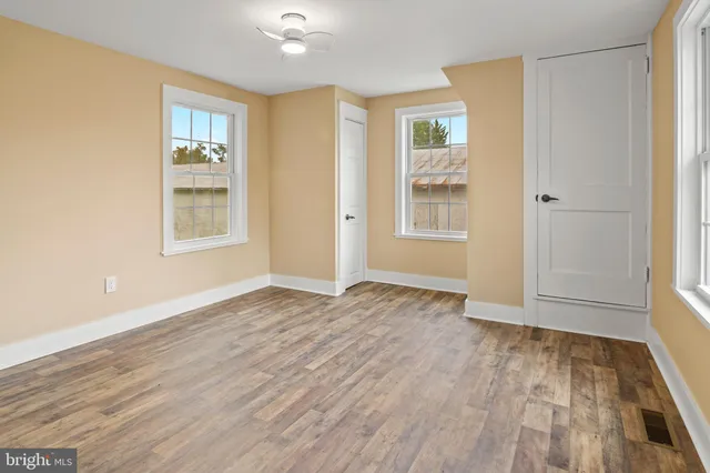 a view of a room with wooden floor
