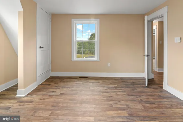 a view of an entryway with wooden floor