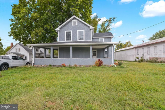 a front view of a house with a garden and yard