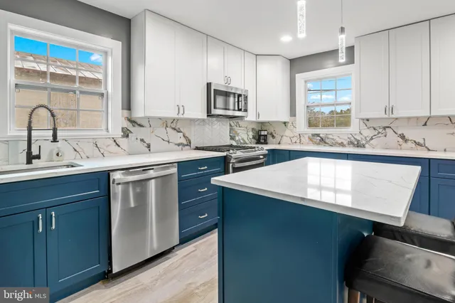a kitchen with a refrigerator and a sink