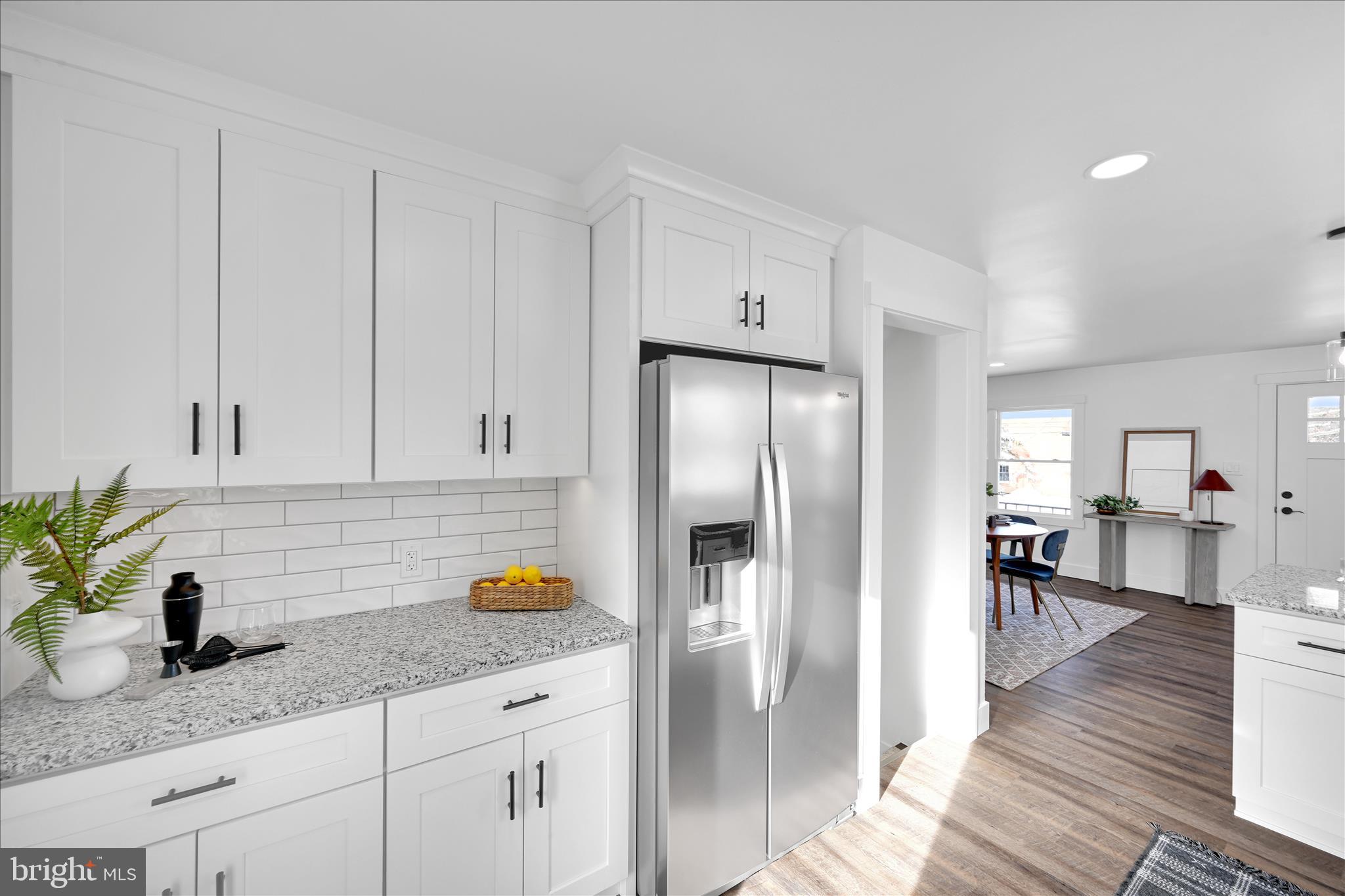 4 Truce Road New Providence, PA 17560 - Photo 6 of 34 a kitchen with granite countertop a refrigerator a stove a sink and white cabinets