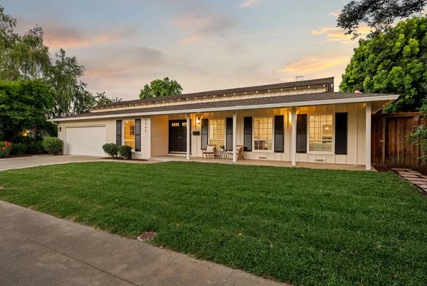 a front view of house with yard and green space