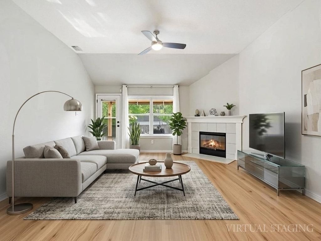 1201 Ridgewood Drive Leander, TX 78641 - Photo 2 of 28 Living area with light wood-style flooring, lofted ceiling, a ceiling fan, and a tile fireplace