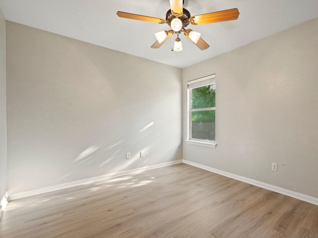 1201 Ridgewood Drive Leander, TX 78641 - Photo 22 of 28 Empty room with light wood finished floors and a ceiling fan