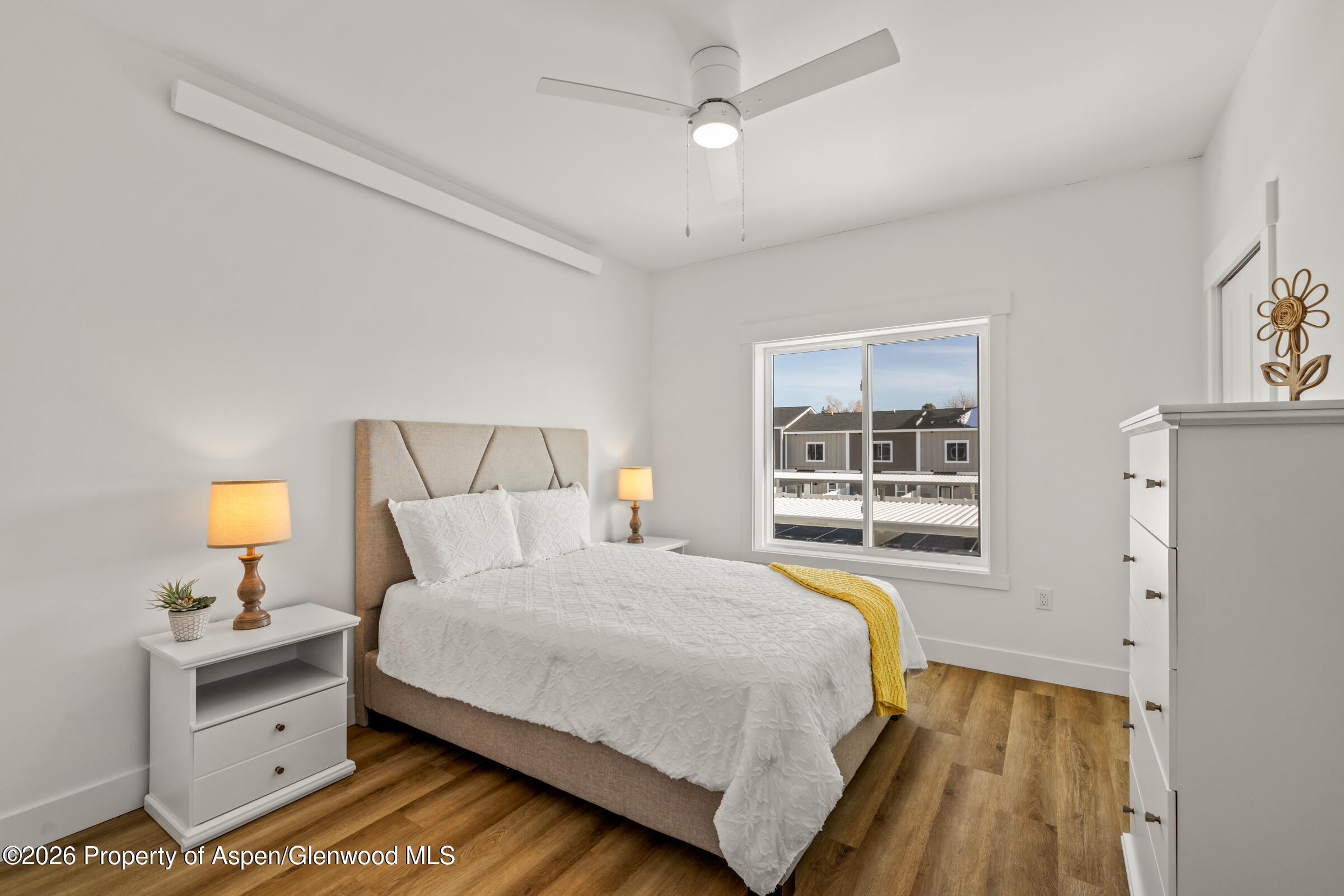 774 Tucker Street Craig, CO 81625 - Photo 14 of 23 a bedroom with a bed and a window