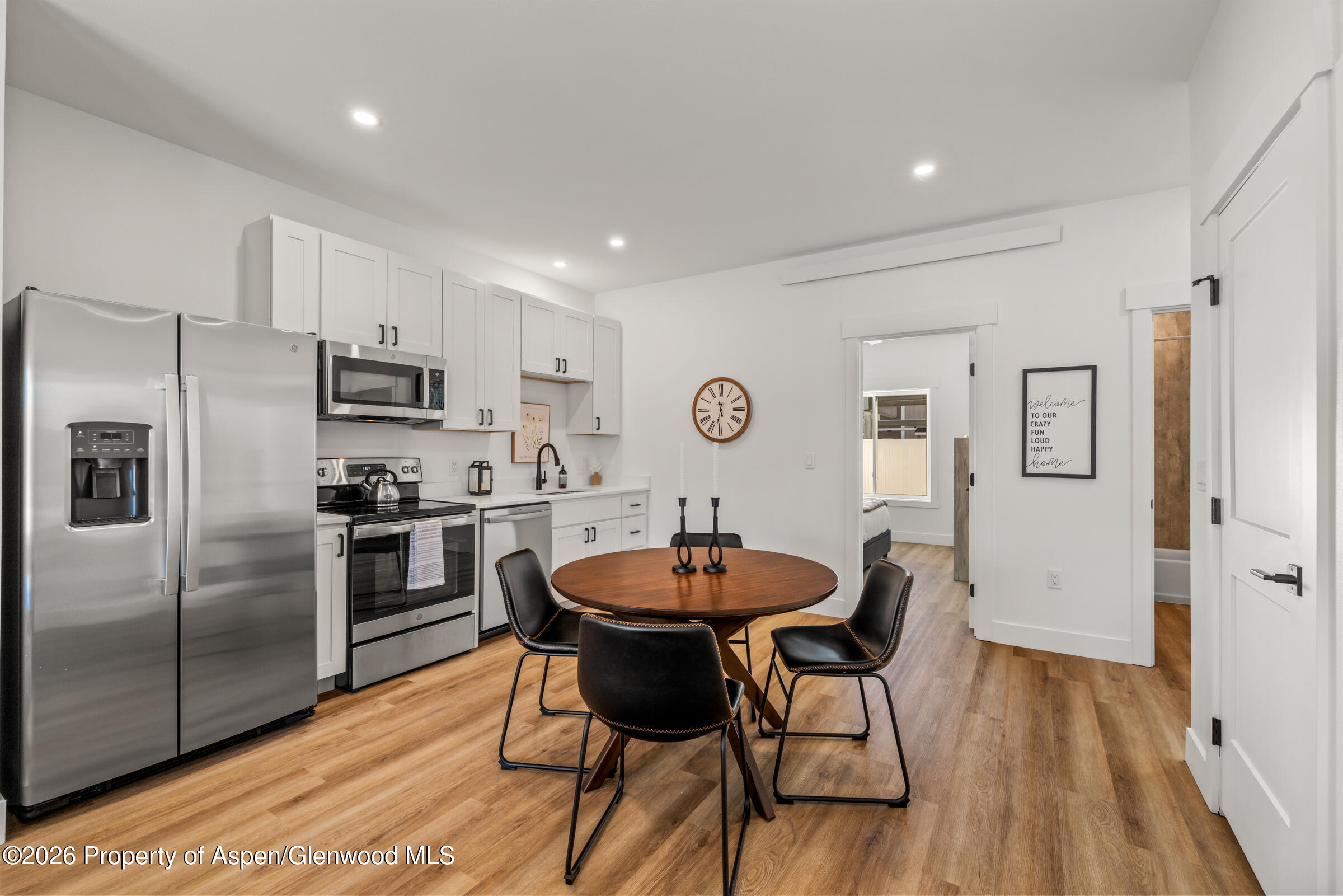 774 Tucker Street Craig, CO 81625 - Photo 8 of 23 a kitchen with stainless steel appliances granite countertop a dining table chairs refrigerator and sink