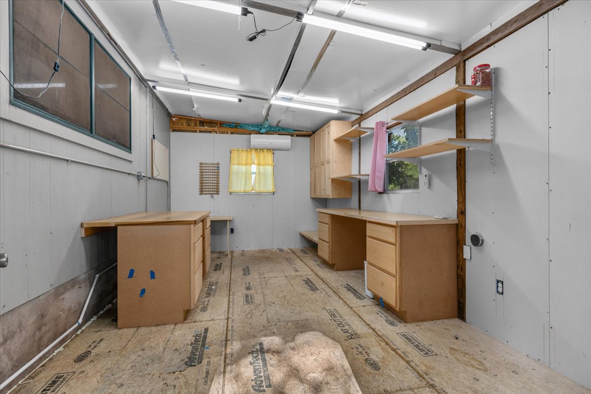 6200 Shadow Bend Austin, TX 78745 - Photo 29 of 33 A versatile workshop space features ample built-in cabinetry, shelving, and generous countertop work areas.