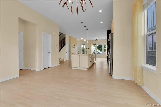a view of a kitchen with a refrigerator kitchen island and a sink