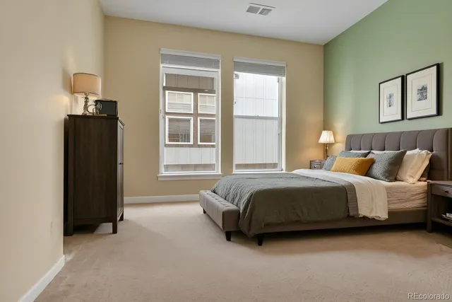 a spacious bedroom with a bed and a window