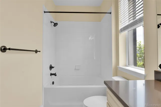 a bathroom with a shower curtain and a toilet