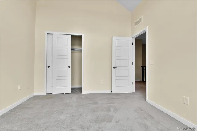 an empty room with closet area