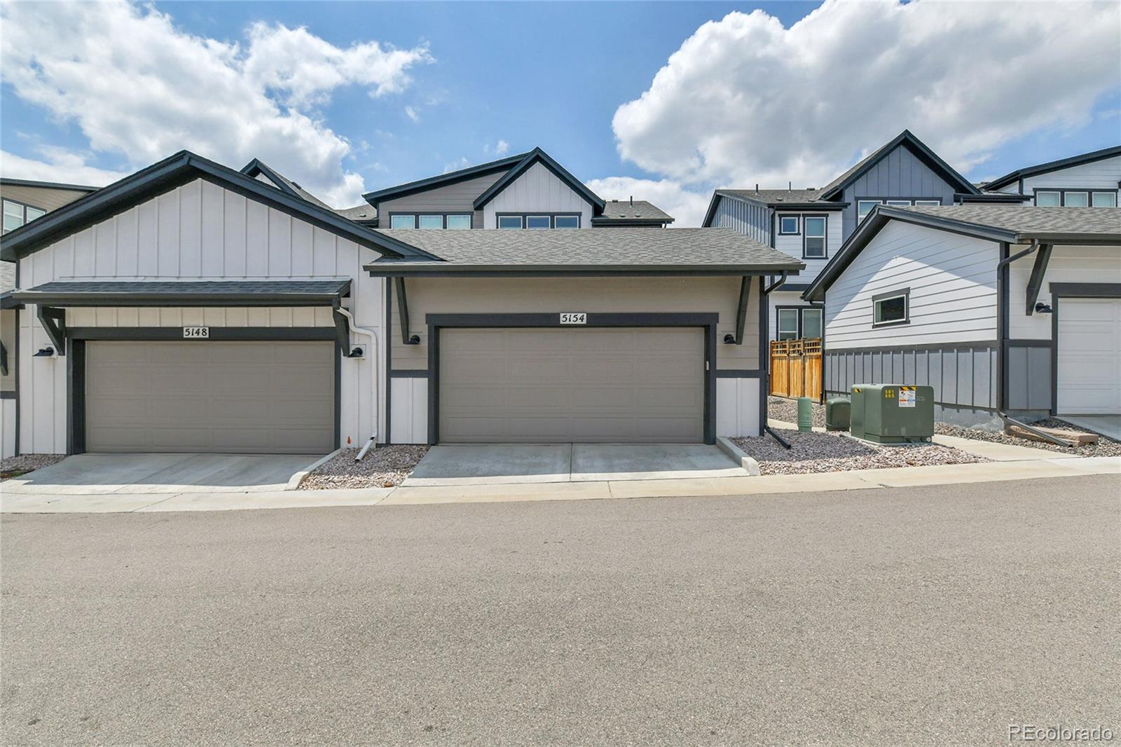5154 Taft Court Wheat Ridge, CO 80033 - Photo 39 of 44 a front view of a house with a yard and garage