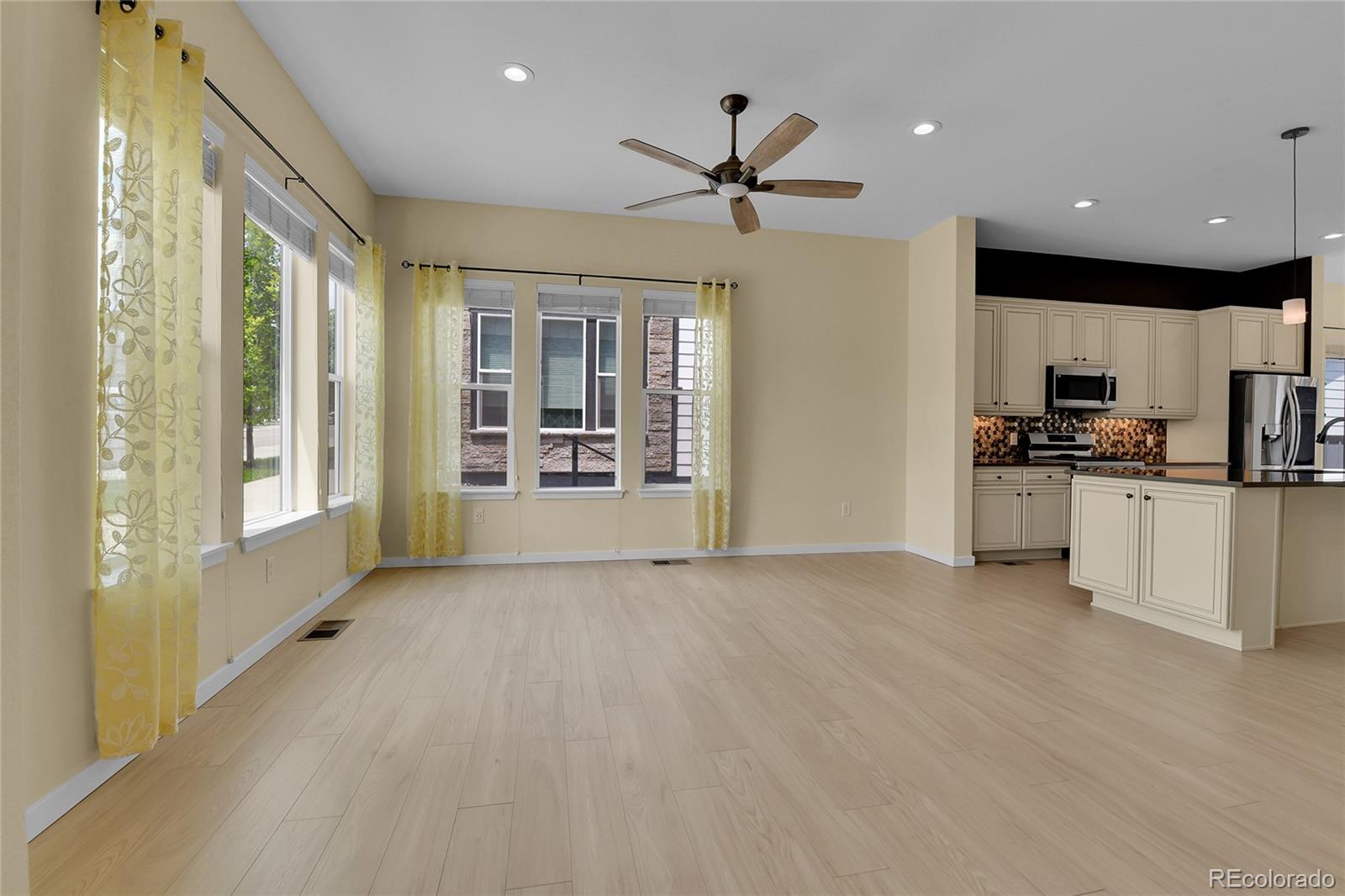 5154 Taft Court Wheat Ridge, CO 80033 - Photo 4 of 44 a view of a kitchen with a sink and dishwasher a refrigerator with wooden floor