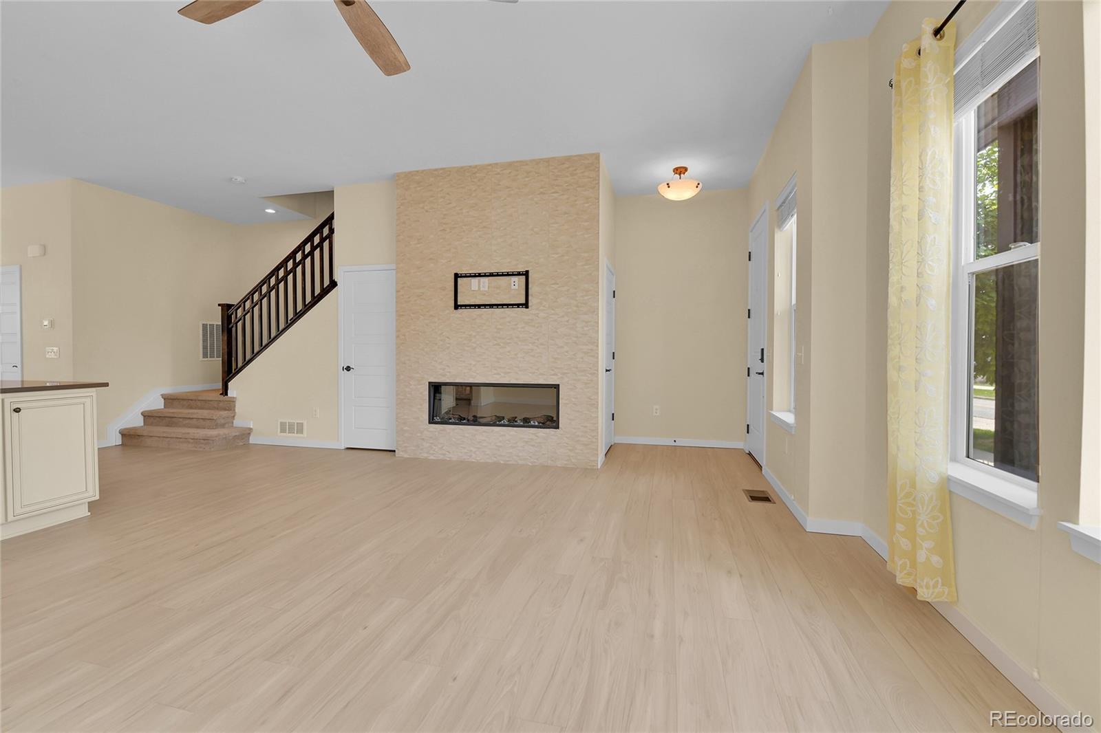 5154 Taft Court Wheat Ridge, CO 80033 - Photo 5 of 44 a view of a livingroom with wooden floor and a ceiling fan