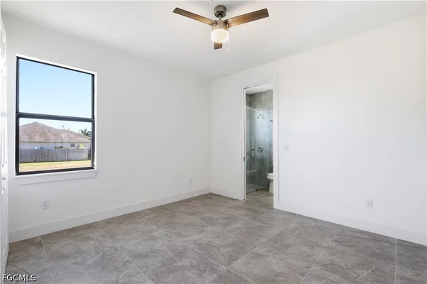 a bathroom with a granite countertop sink a toilet and shower