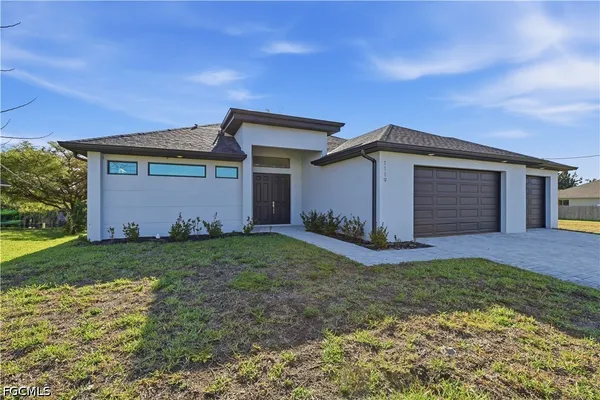 a front view of a house with a yard