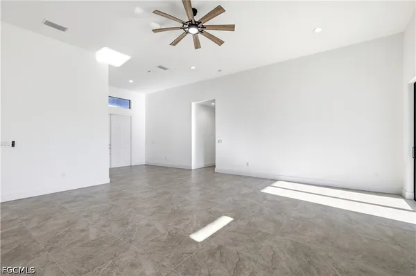 a view of a kitchen with refrigerator and window