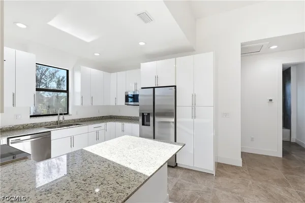 a kitchen with stainless steel appliances granite countertop a stove and a sink