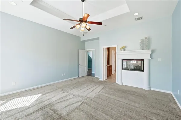 a view of a room with a ceiling fan