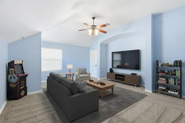 a living room with furniture and a flat screen tv