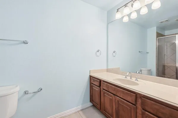 a bathroom with a sink vanity and a mirror