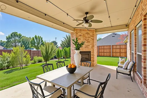 a view of a patio with a table and chairs