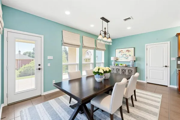 a view of a dining room with furniture wooden floor and chandelier