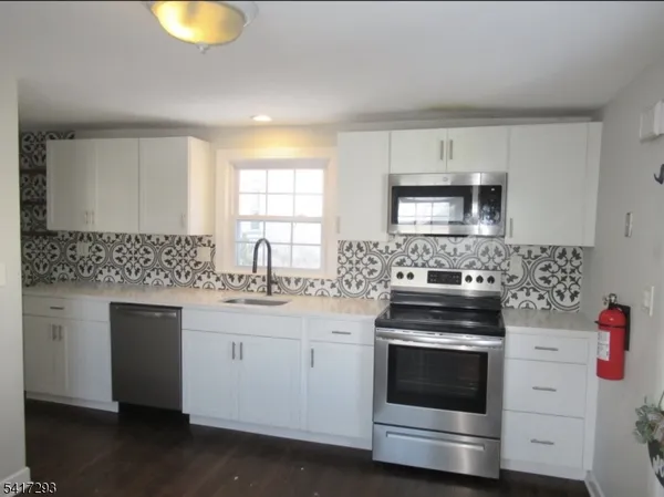 a kitchen with a stove and a sink