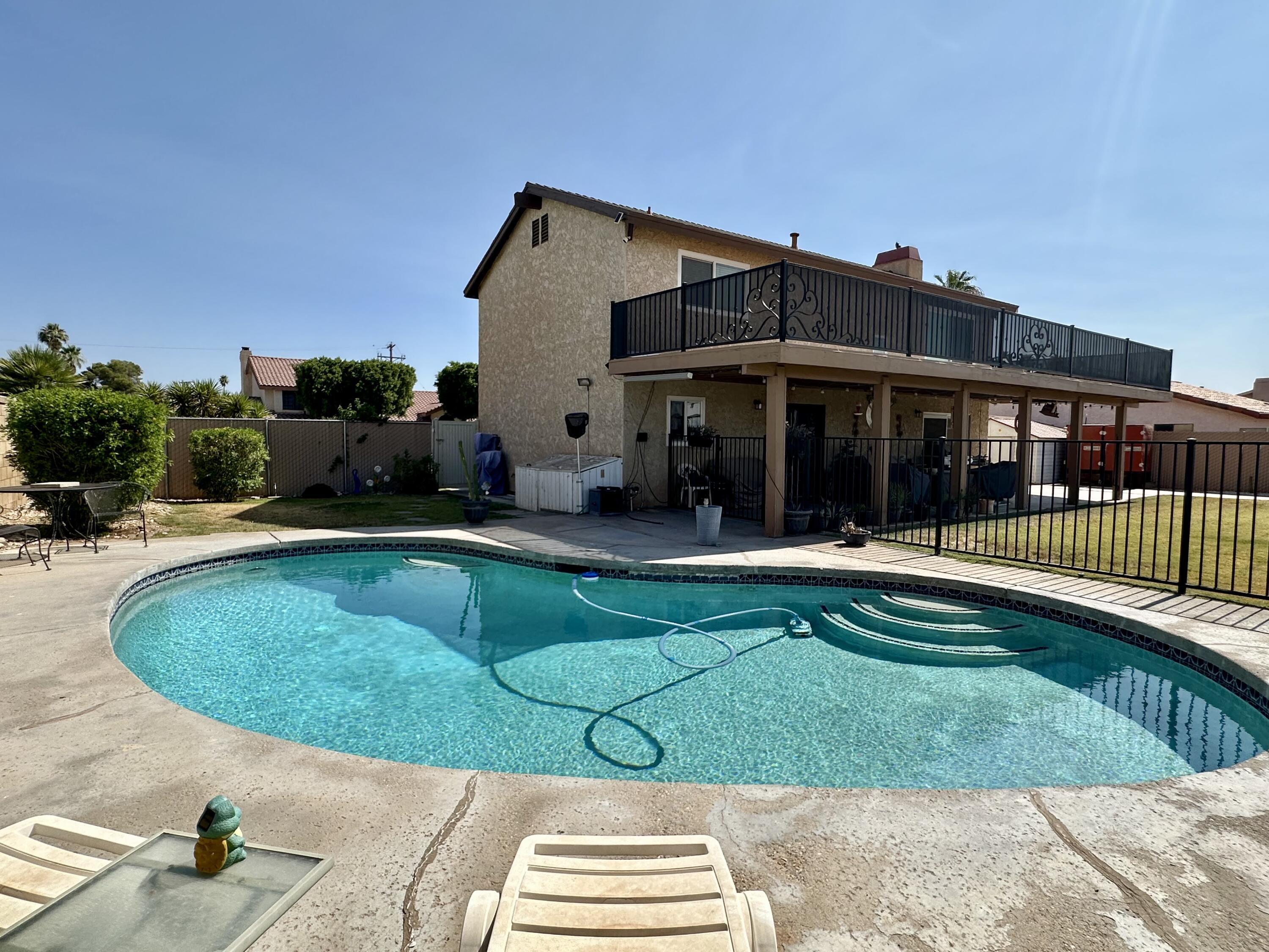 a view of a house with backyard porch and sitting area
