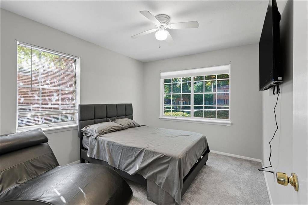 2427 Lawrenceville Highway, Unit 4B Decatur, GA 30033 - Photo 15 of 22 a bedroom with a bed window and a flat tv screen