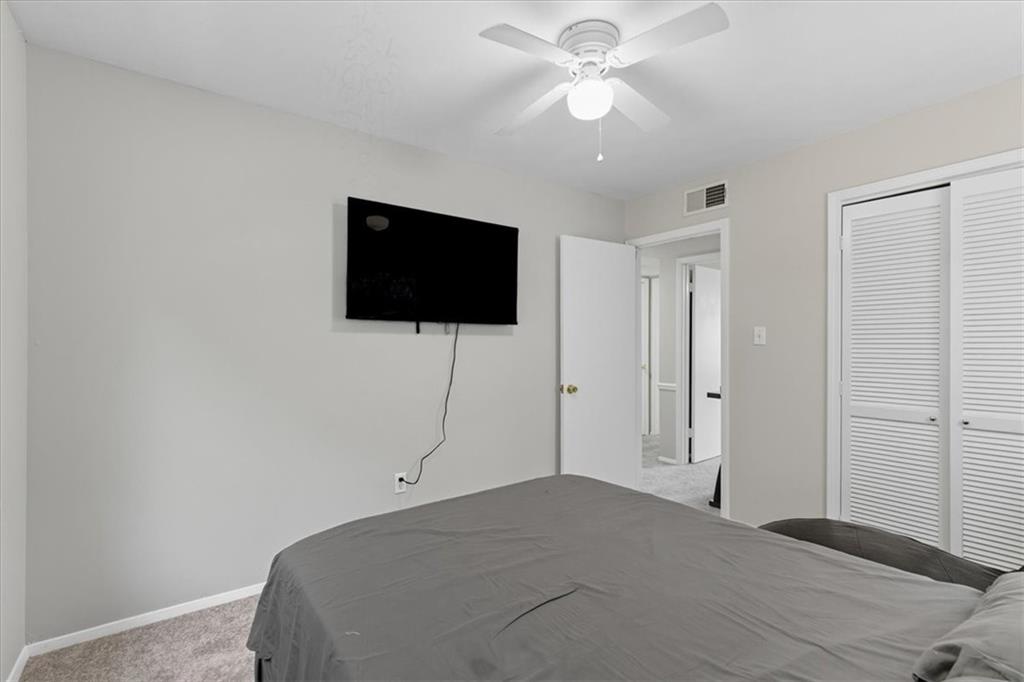 2427 Lawrenceville Highway, Unit 4B Decatur, GA 30033 - Photo 16 of 22 a bedroom with a bed and a flat screen tv