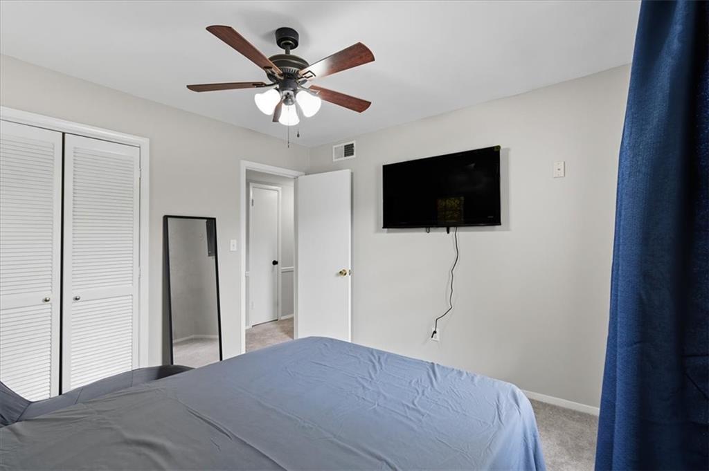 2427 Lawrenceville Highway, Unit 4B Decatur, GA 30033 - Photo 18 of 22 a bedroom with a bed and a flat screen tv