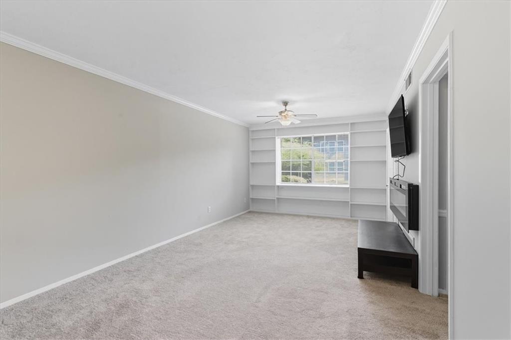 2427 Lawrenceville Highway, Unit 4B Decatur, GA 30033 - Photo 6 of 22 a view of livingroom with furniture flat screen tv and window