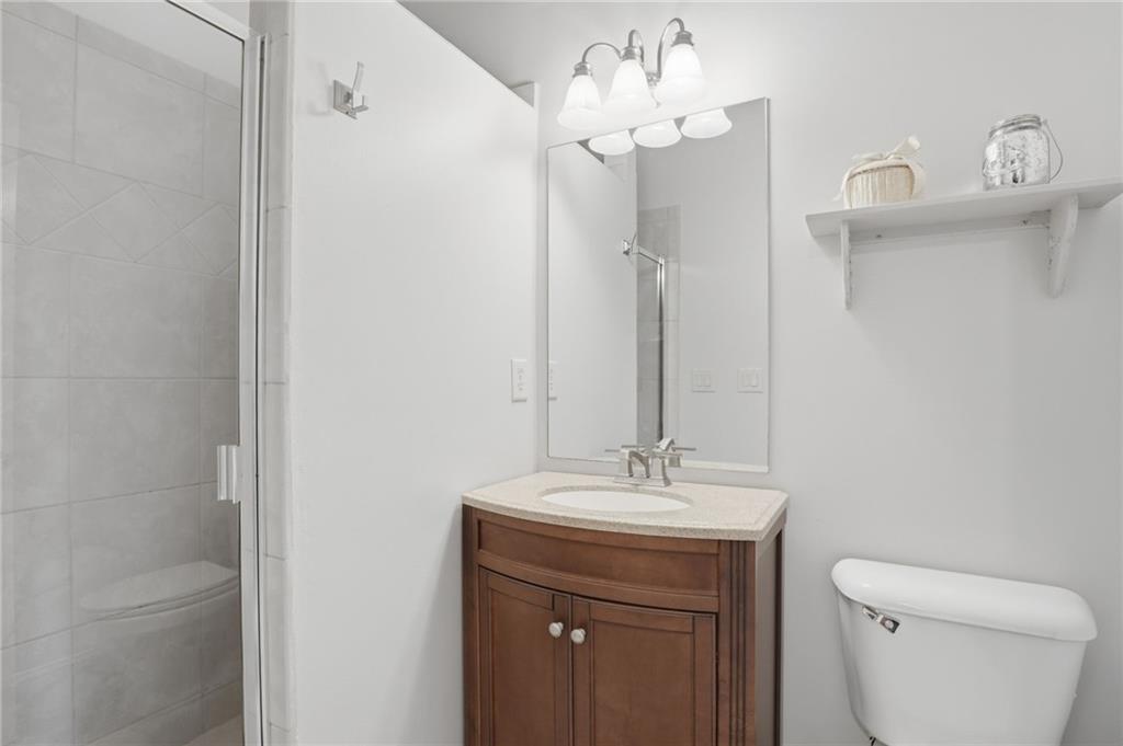 2950 Callie Still Road Lawrenceville, GA 30045 - Photo 32 of 77 a bathroom with a sink a toilet and a mirror