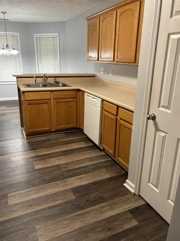 a kitchen with stainless steel appliances granite countertop a sink and a stove top oven