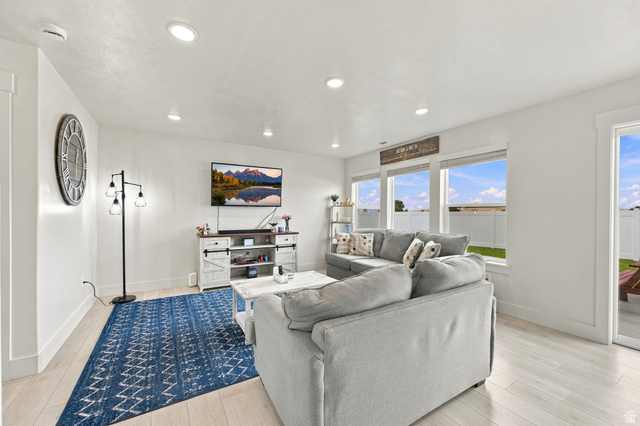 1566 Silver Canoe Loop Logan, UT 84321 - Photo 14 of 44 Recessed ceiling lighting, wood-finish flooring, multiple windows, and a sliding glass door