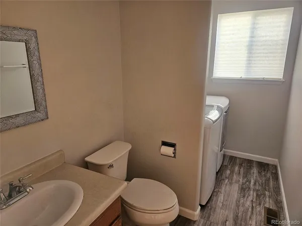 a white toilet sitting next to a bathroom sink