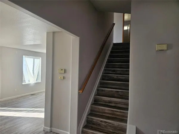 a view of entryway and hall with wooden floor