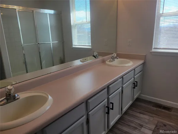 a bathroom with a double vanity sink and mirror