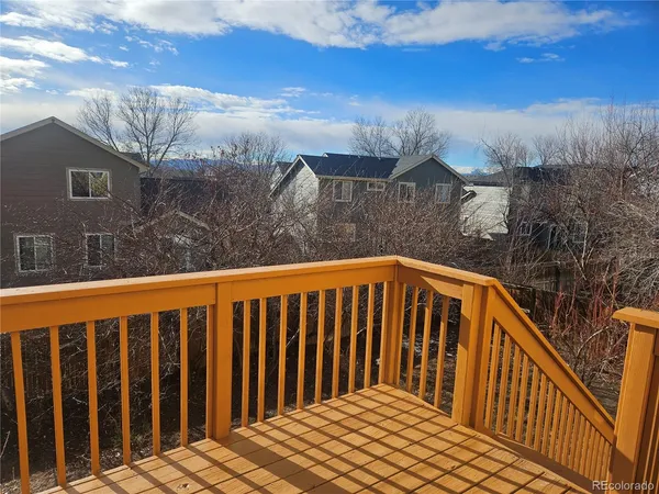 a view of a balcony with wooden fence