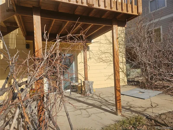 a view of a yard with wooden fence