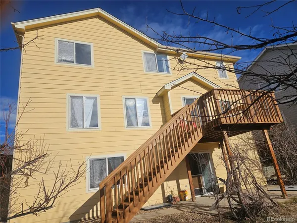 a view of a house with wooden deck