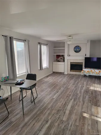 a living room with furniture and a fireplace