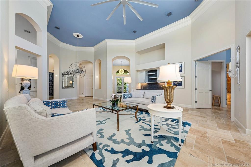 7000 Southeast Lakeview Terrace Stuart, FL 34996 - Photo 19 of 56 a living room with furniture and a chandelier