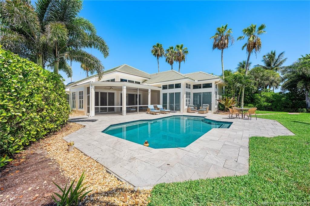 7000 Southeast Lakeview Terrace Stuart, FL 34996 - Photo 2 of 56 a front view of a house with a yard and potted plants